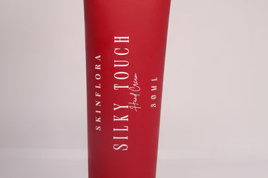 Silky Touch hand cream tube with luxury red packaging